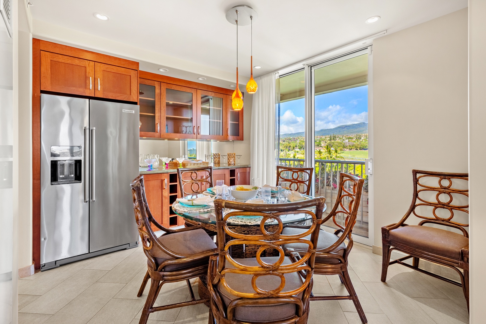 Gather around the glass-topped dining table and soak in sweeping mountain views through your open balcony doors. The fully equipped kitchen makes meal prep a breeze.