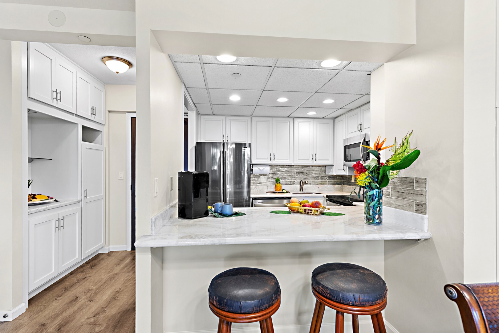 Gather in your bright open kitchen with a spacious island for meal prep, modern appliances, and charming bar seating perfect for morning coffee or conversation.