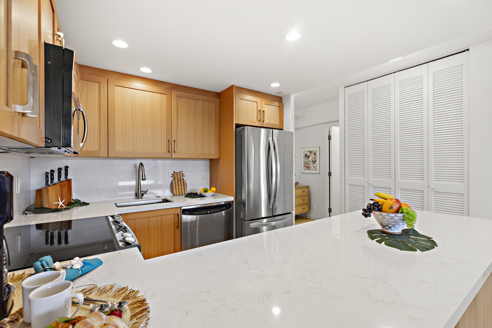 Step into your fully equipped kitchen, where gleaming countertops and modern stainless-steel appliances invite you to whip up your favorite meals or enjoy morning coffee with ease.