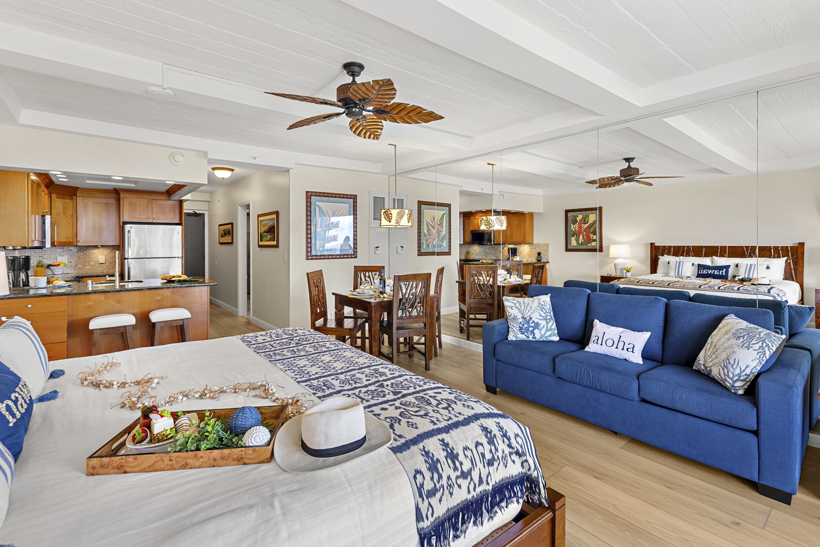 Relax in your spacious open-plan retreat with coastal blue accents, tropical ceiling fans, and a fully-equipped kitchen.