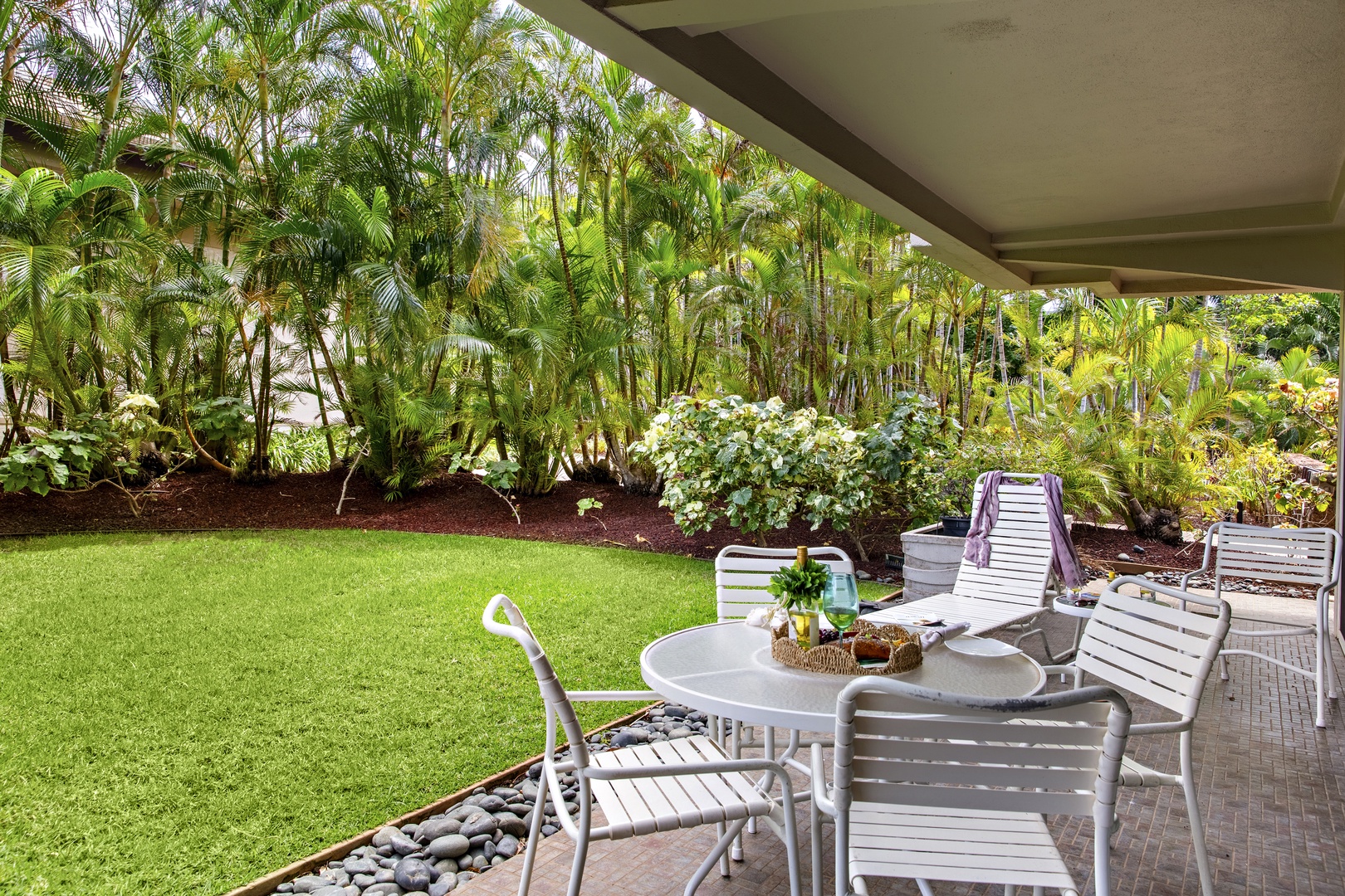 Relax on your private patio surrounded by lush tropical gardens and manicured lawn—your perfect outdoor retreat awaits.