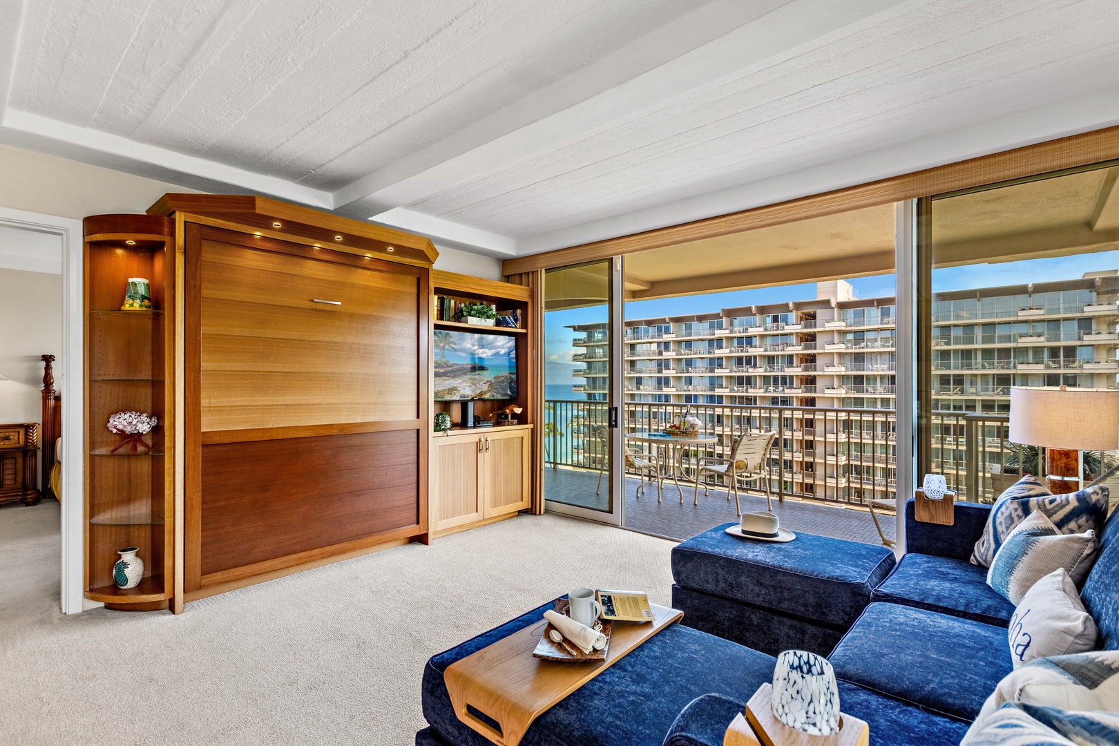 Sink into plush blue sofas as ocean breezes flow through your private balcony. Your entertainment center awaits for cozy movie nights.