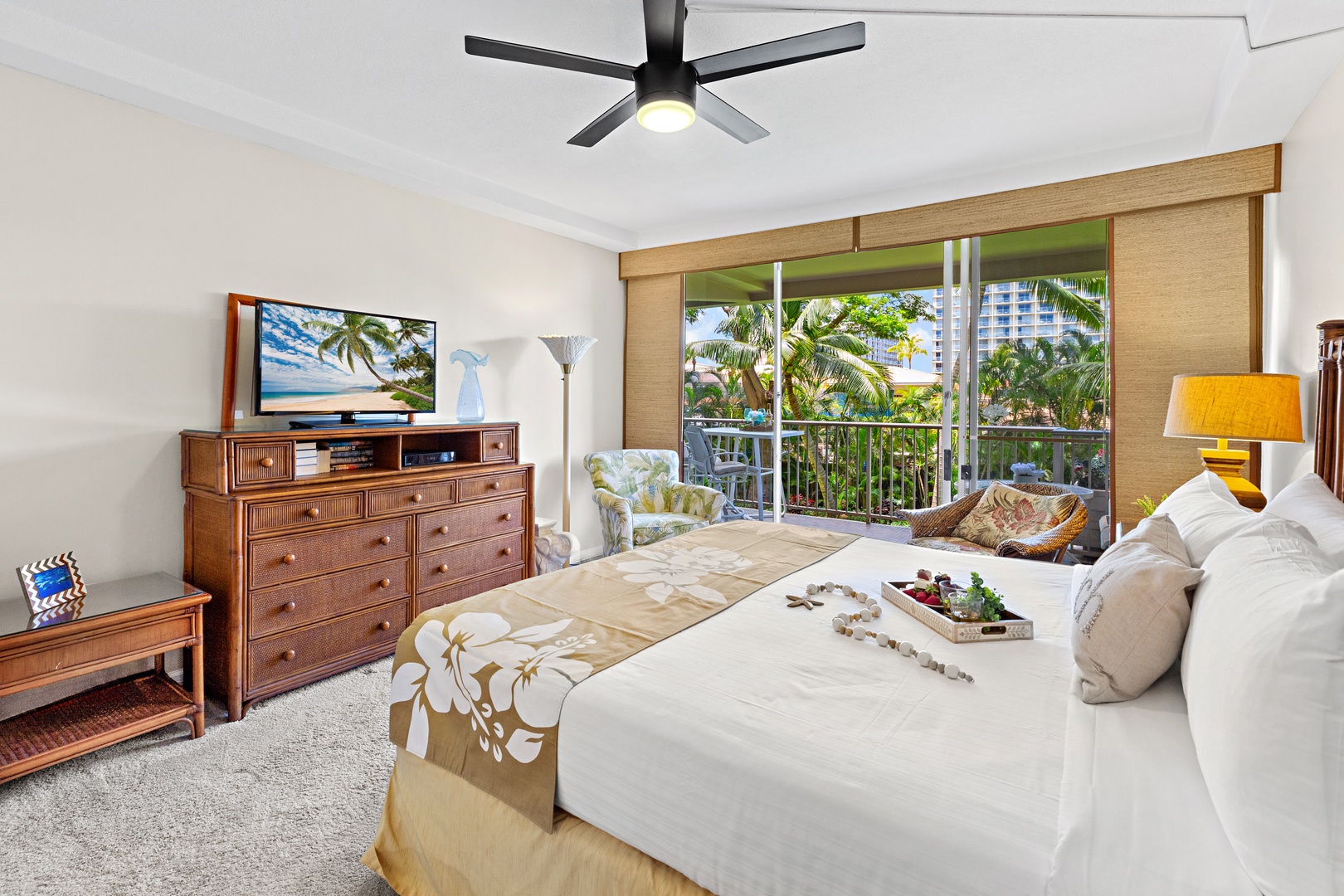 Wake to tropical breezes and lush greenery outside your window. Your private retreat features ceiling fan comfort, island-style furnishings, and a cozy spot to unwind with palm trees swaying just beyond your balcony.