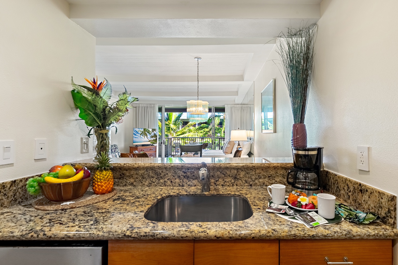 Bright and inviting open-concept kitchen featuring cabinetry, sleek countertops, and a spacious island that flows seamlessly into the living and dining areas. Perfect for entertaining or relaxing in comfort.