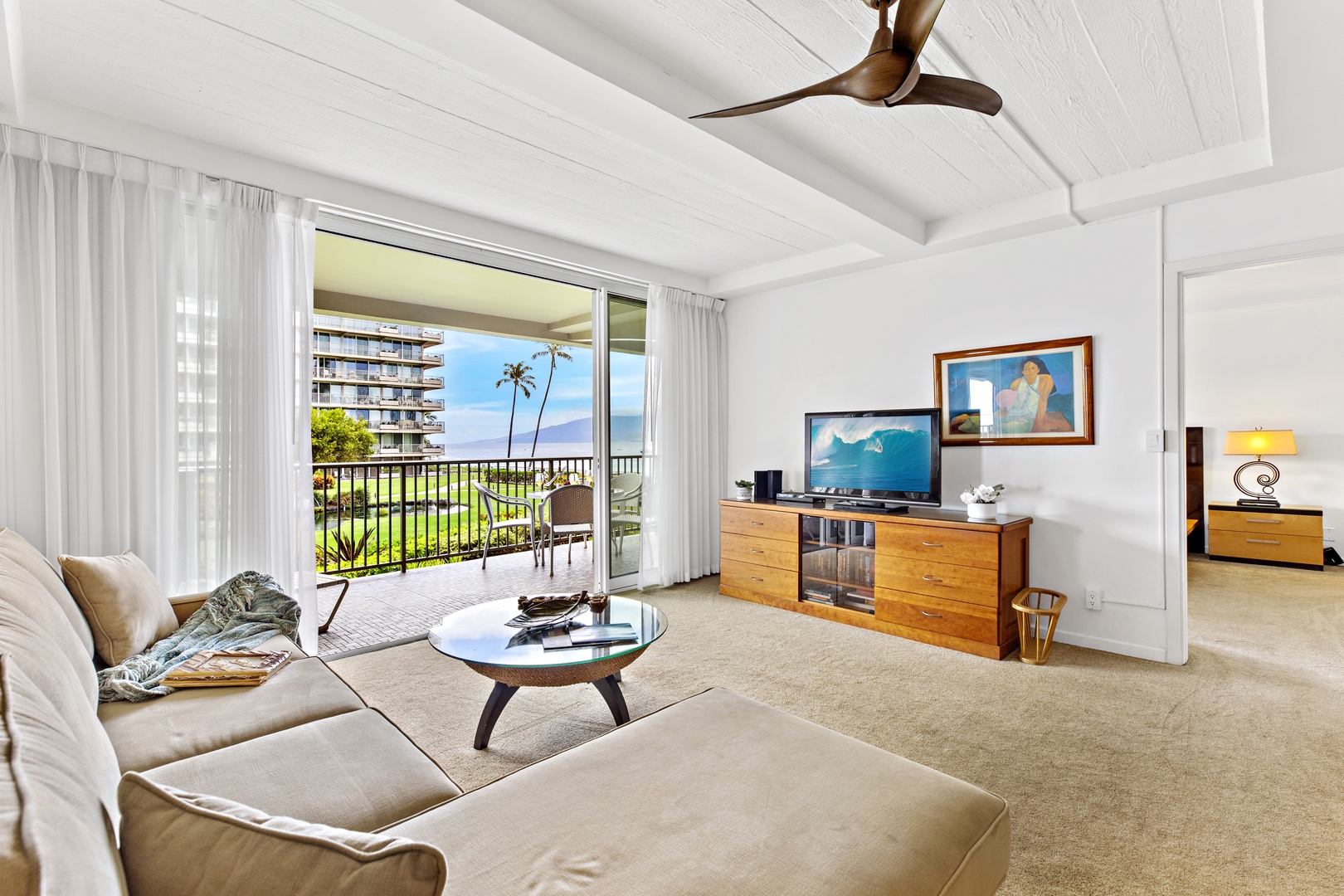 Relax in your airy living room with ocean breezes flowing through sliding doors to your private balcony overlooking tropical gardens.