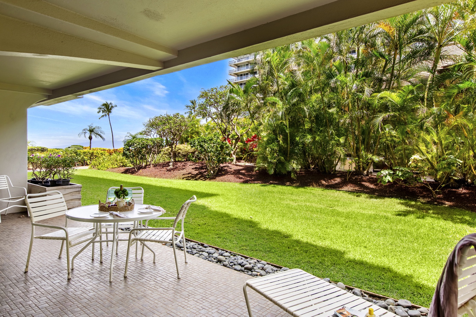Step onto your private patio where morning coffee tastes better surrounded by lush tropical gardens and endless blue skies.