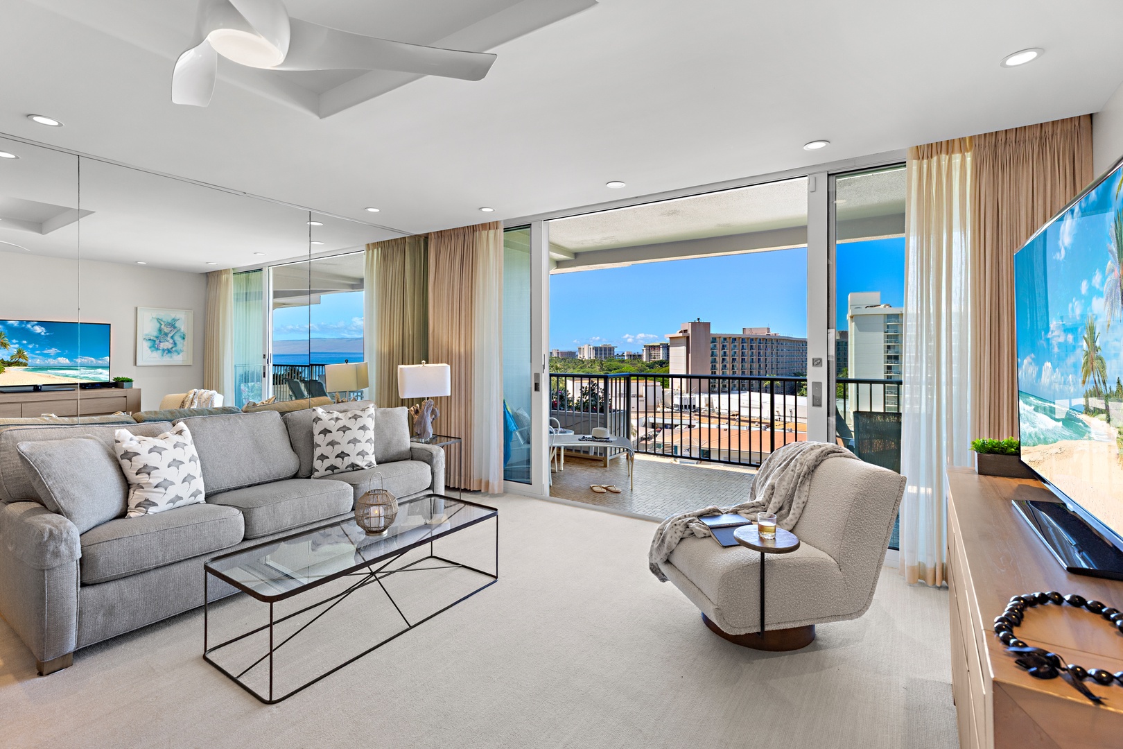 Sink into the plush sofa and soak up ocean breezes through floor-to-ceiling windows that frame your private balcony, where city and sea views await.