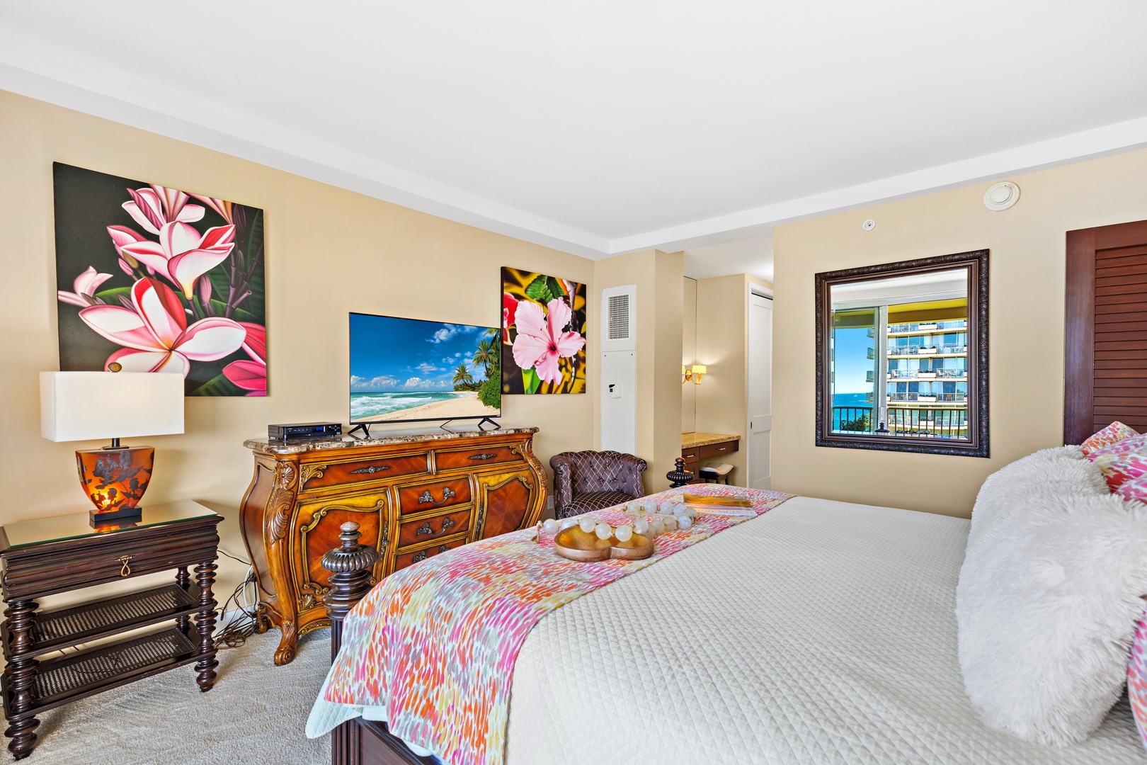 Drift off in this peaceful bedroom, where colorful art brightens the walls and your private mirror frames a calming ocean view through the window.