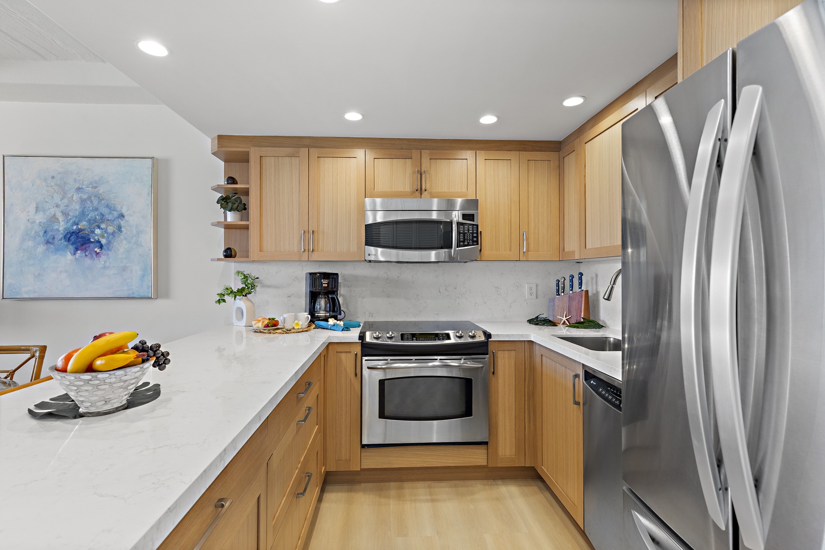 Your bright, modern kitchen awaits, equipped with stainless steel appliances, sleek countertops, and all the essentials for crafting meals together during your stay.