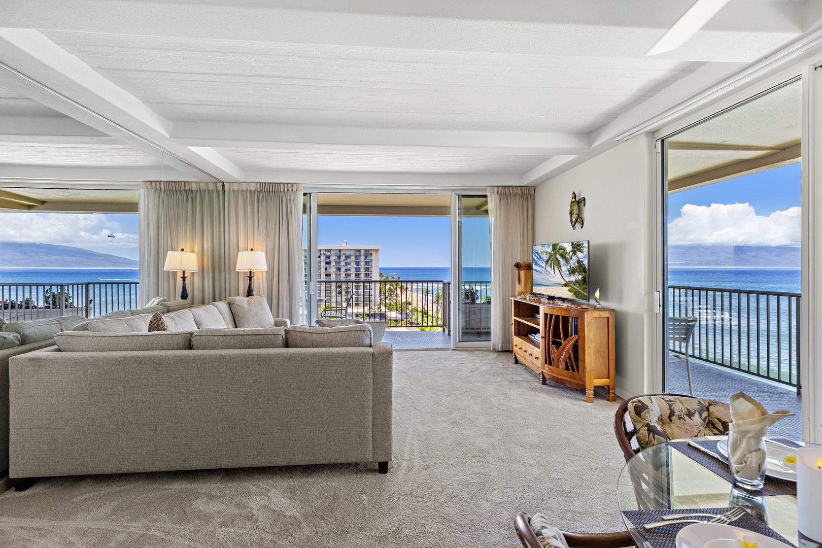 Panoramic ocean views greet you from this spacious living room, where floor-to-ceiling windows frame the endless blue horizon, inviting you to unwind in comfort and soak in breathtaking coastal scenery.