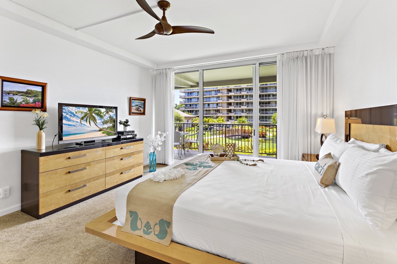 Wake up to serene garden views from your comfortable bed, with modern amenities and tropical breezes from the ceiling fan.