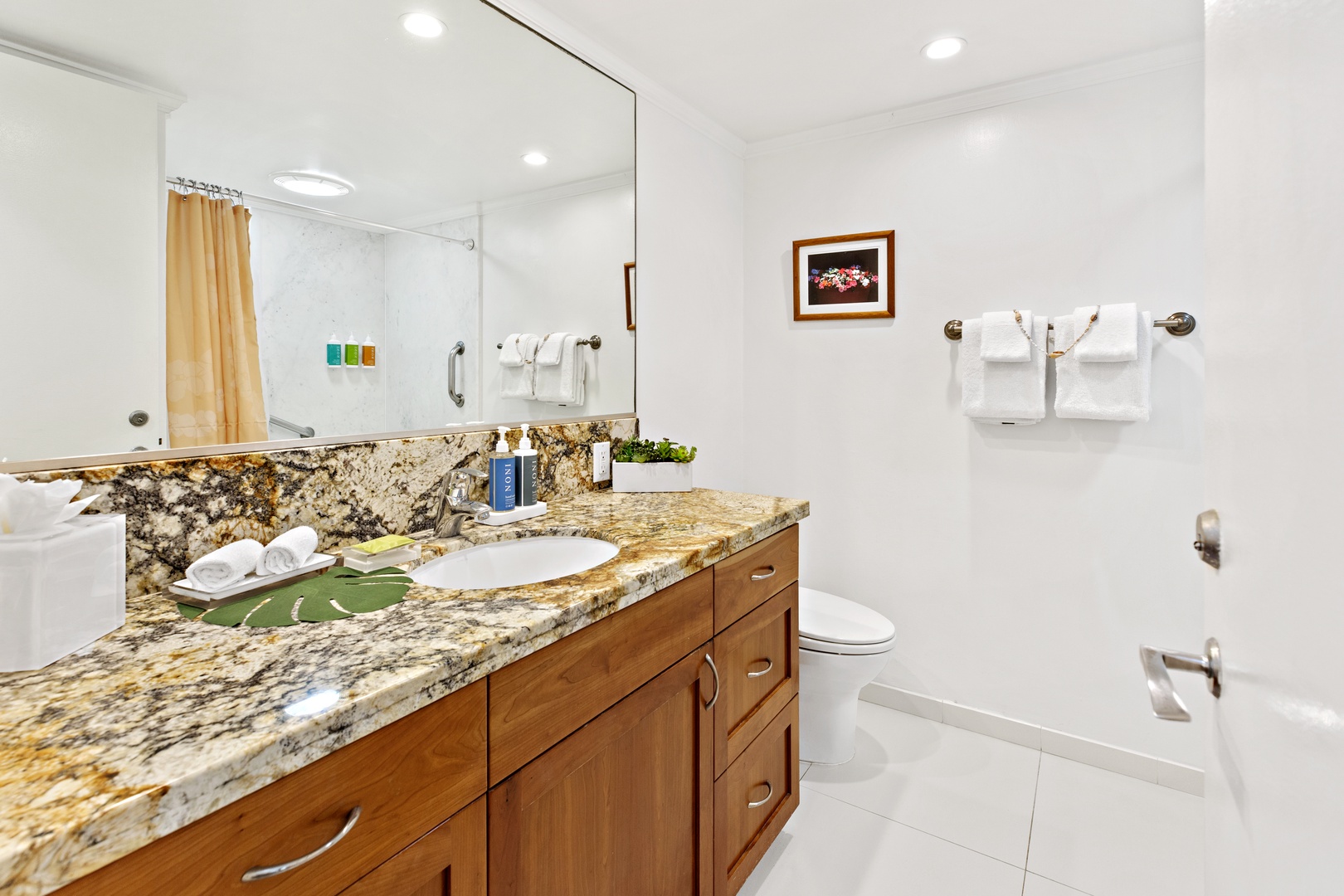 Step into your spa-like bathroom with gleaming granite counters, fluffy towels, and premium amenities waiting for your relaxing retreat.