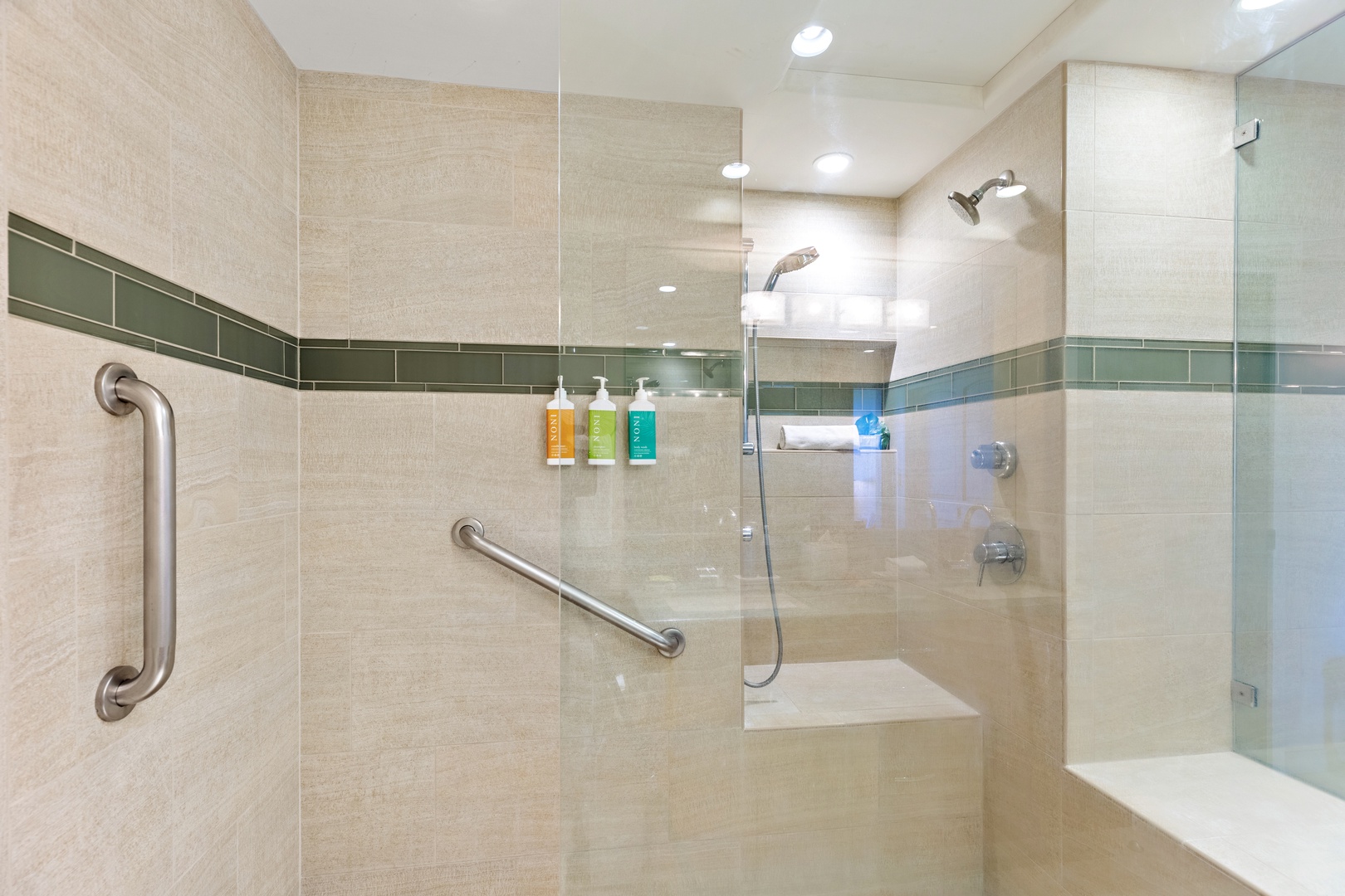Step into your spacious walk-in shower with dual showerheads and thoughtful accessibility features. Sleek tile accents in soothing neutral tones create a spa-like atmosphere where you can unwind after a day of adventure.