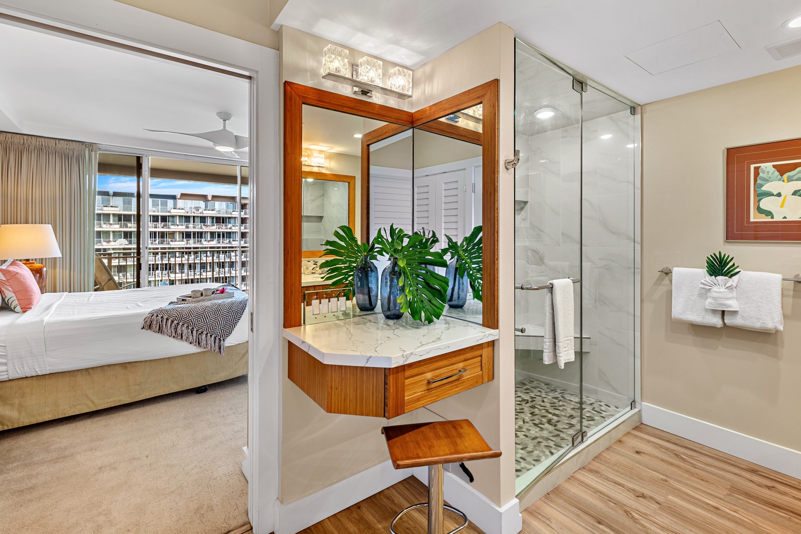 Step into your elegant ensuite bathroom featuring warm wood vanity, marble counters, and a spacious glass shower—your private sanctuary awaits.
