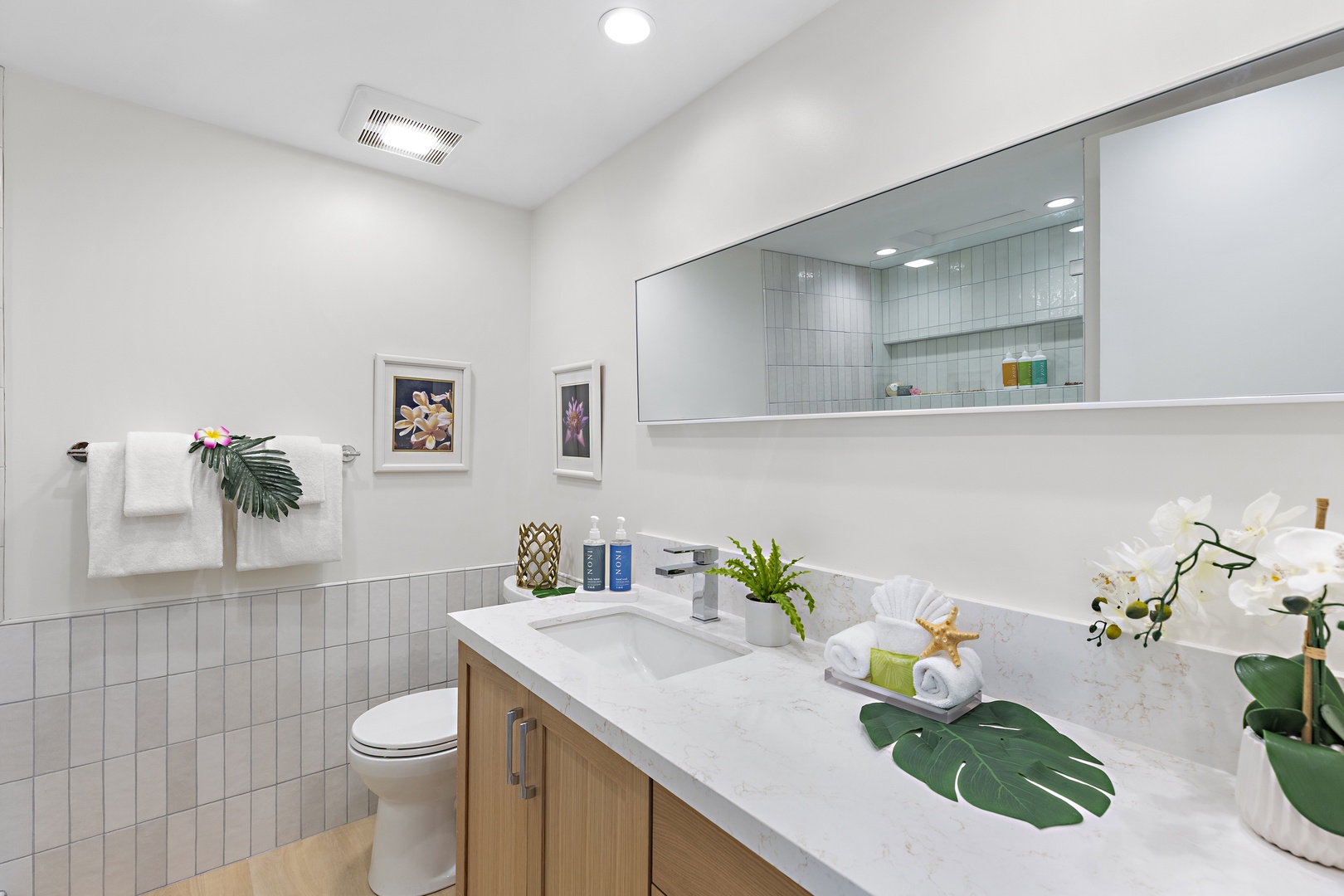 Your bright, coastal-inspired bathroom features a spacious vanity and soothing tropical touches. Fresh linens and beach-themed accents await your arrival.