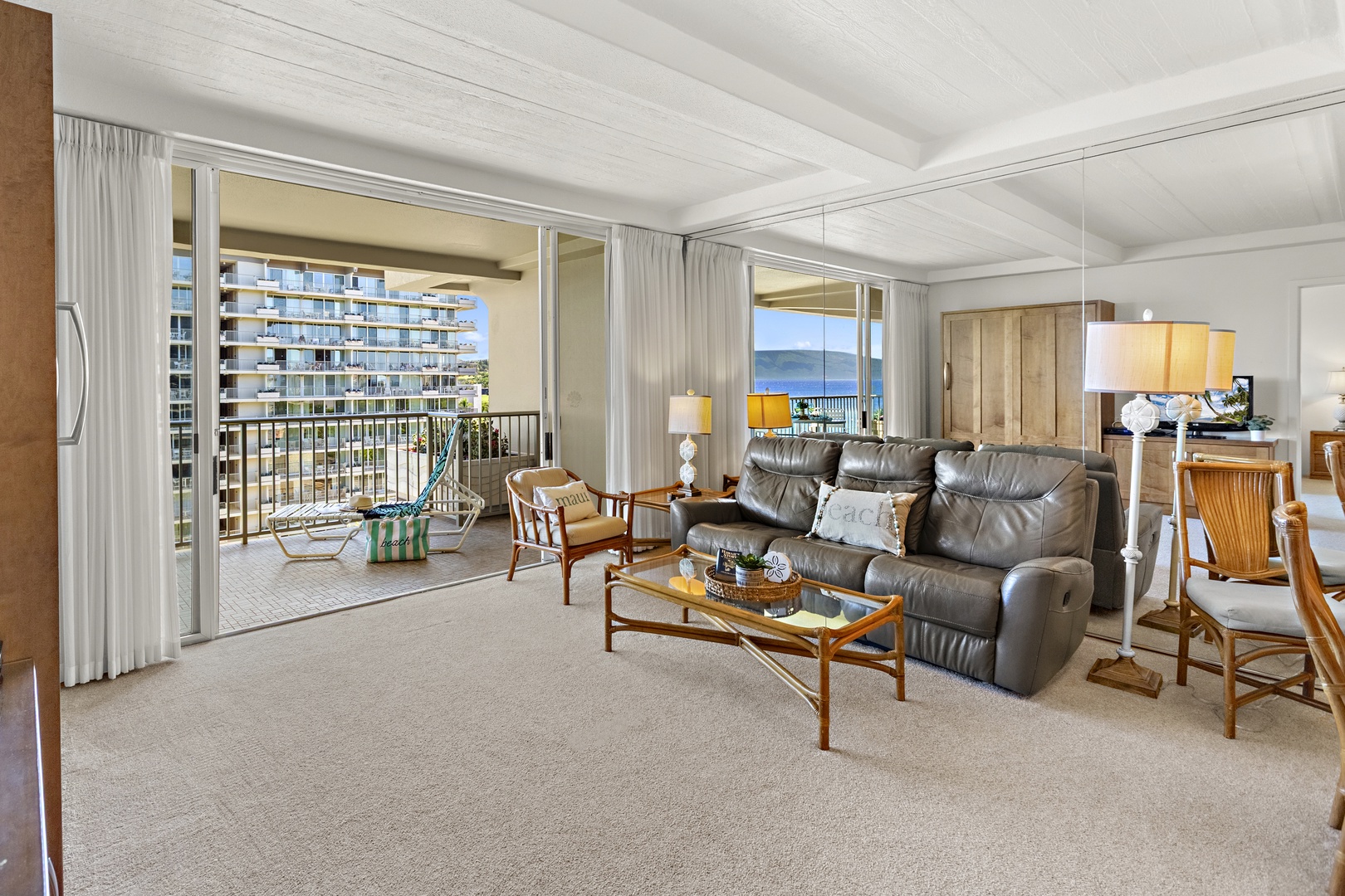Comfortable living area featuring a plush recliner sofa, open layout, and large sliding doors leading to the balcony.