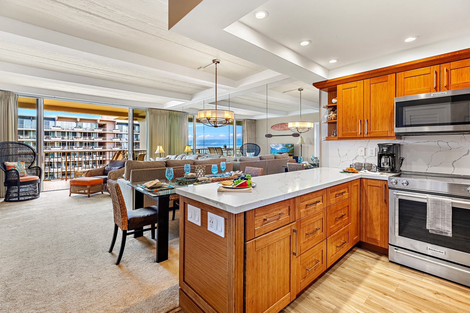 Your gourmet kitchen features rich wood cabinetry and a spacious island where you'll craft memorable meals while enjoying stunning ocean views.