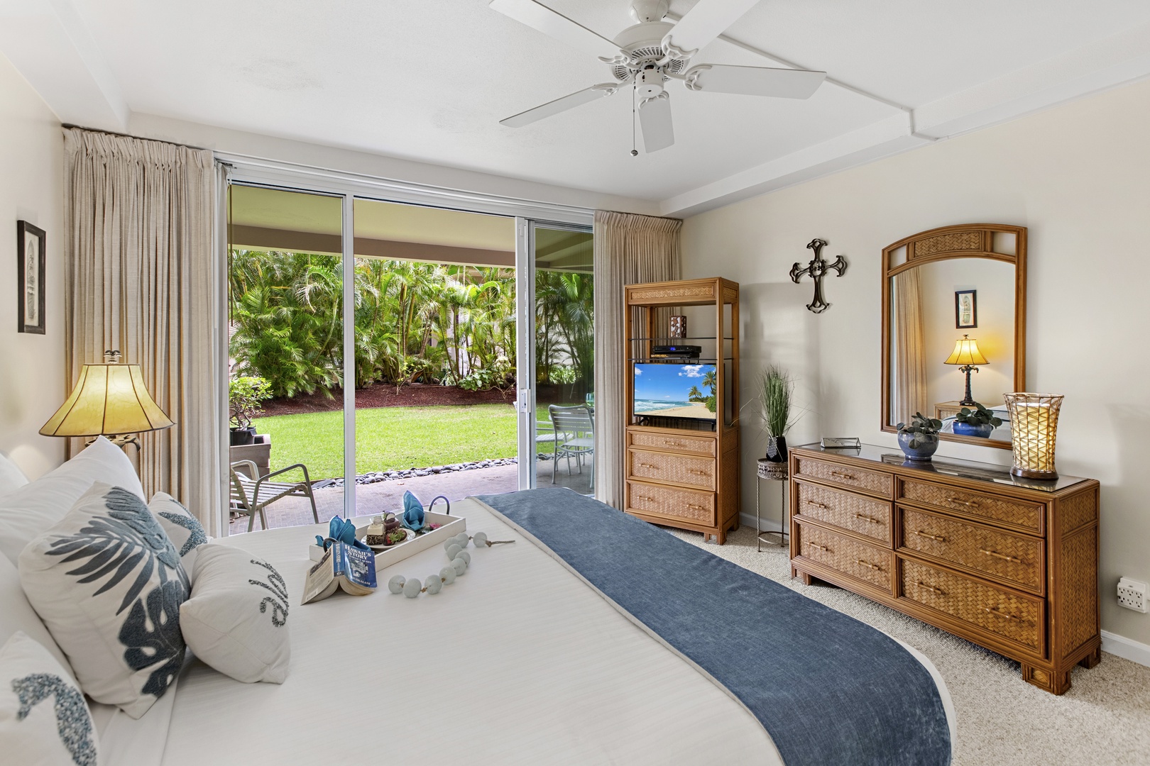 Wake up to tropical garden views through sliding glass doors, your private oasis just steps from your elegant bedroom.