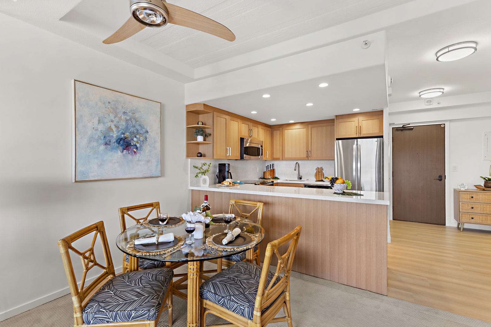 Step into your bright, open-concept living space where a stylish dining area flows seamlessly into a modern kitchen. The warm wood tones and sleek finishes invite you to settle in and feel at home.
