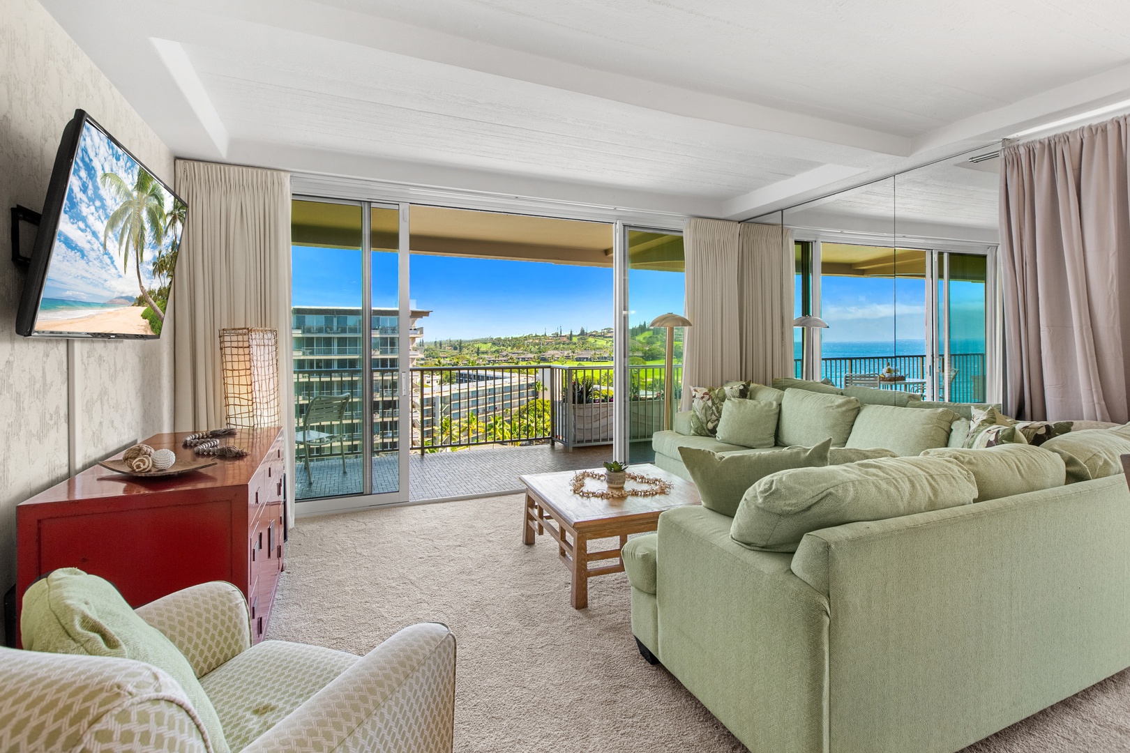 Settle into the plush sectional and soak in sweeping ocean views through floor-to-ceiling glass—your perfect perch for morning coffee or sunset cocktails.