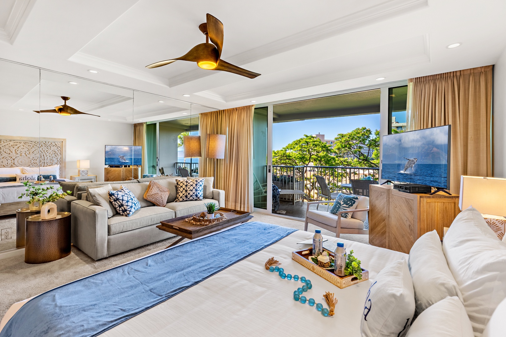 Settle into your sunlit living space with plush seating, ocean breezes, and a private balcony framing lush island views just steps away.