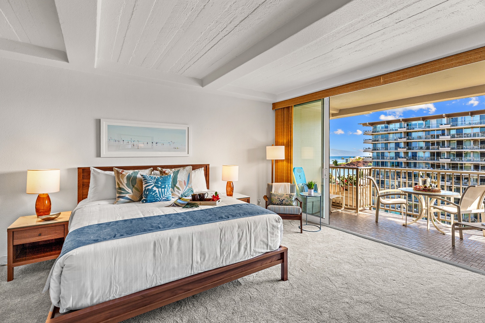 Wake up to stunning ocean views from your private balcony, where the sound of waves and warm tropical breezes welcome each morning in this serene, sunlit bedroom retreat.