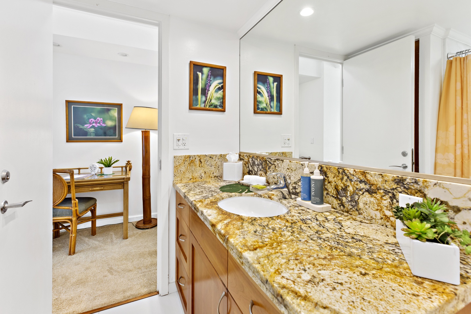Your elegant ensuite bathroom features stunning granite countertops, premium amenities, and warm lighting for your comfort and relaxation.
