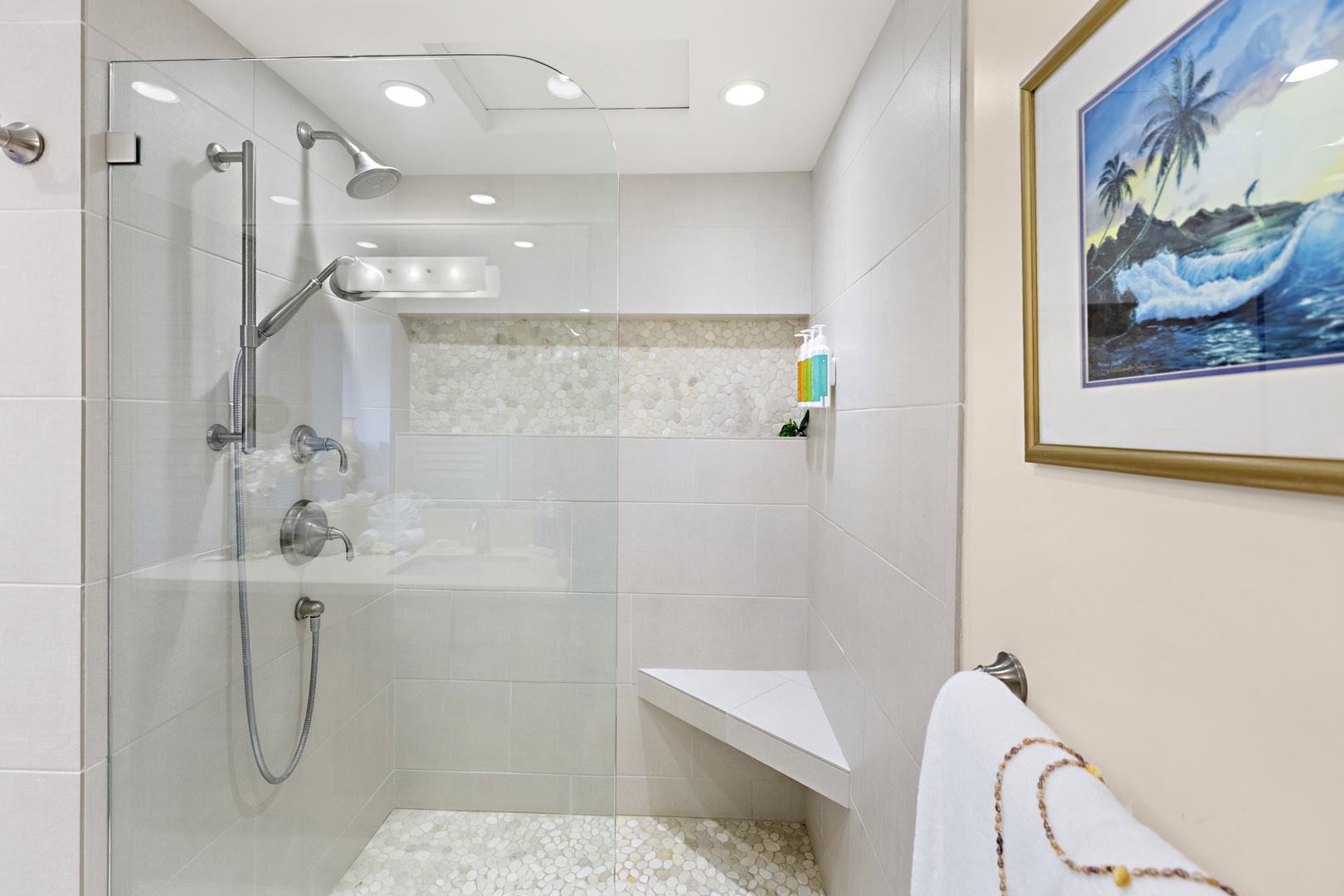 Contemporary walk-in shower with sleek tilework, built-in bench, and glass enclosure for a spa-like experience.