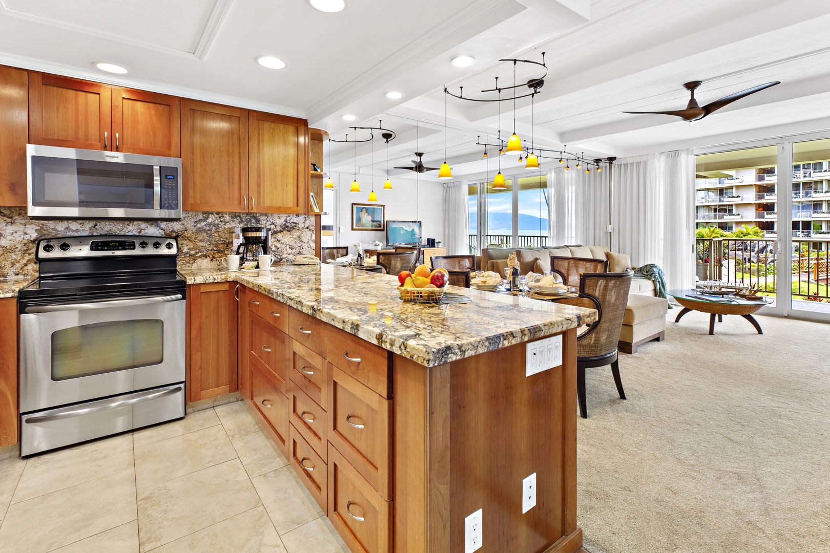 Your open-concept kitchen flows seamlessly into the living area, featuring granite countertops and stainless appliances perfect for preparing tropical meals.