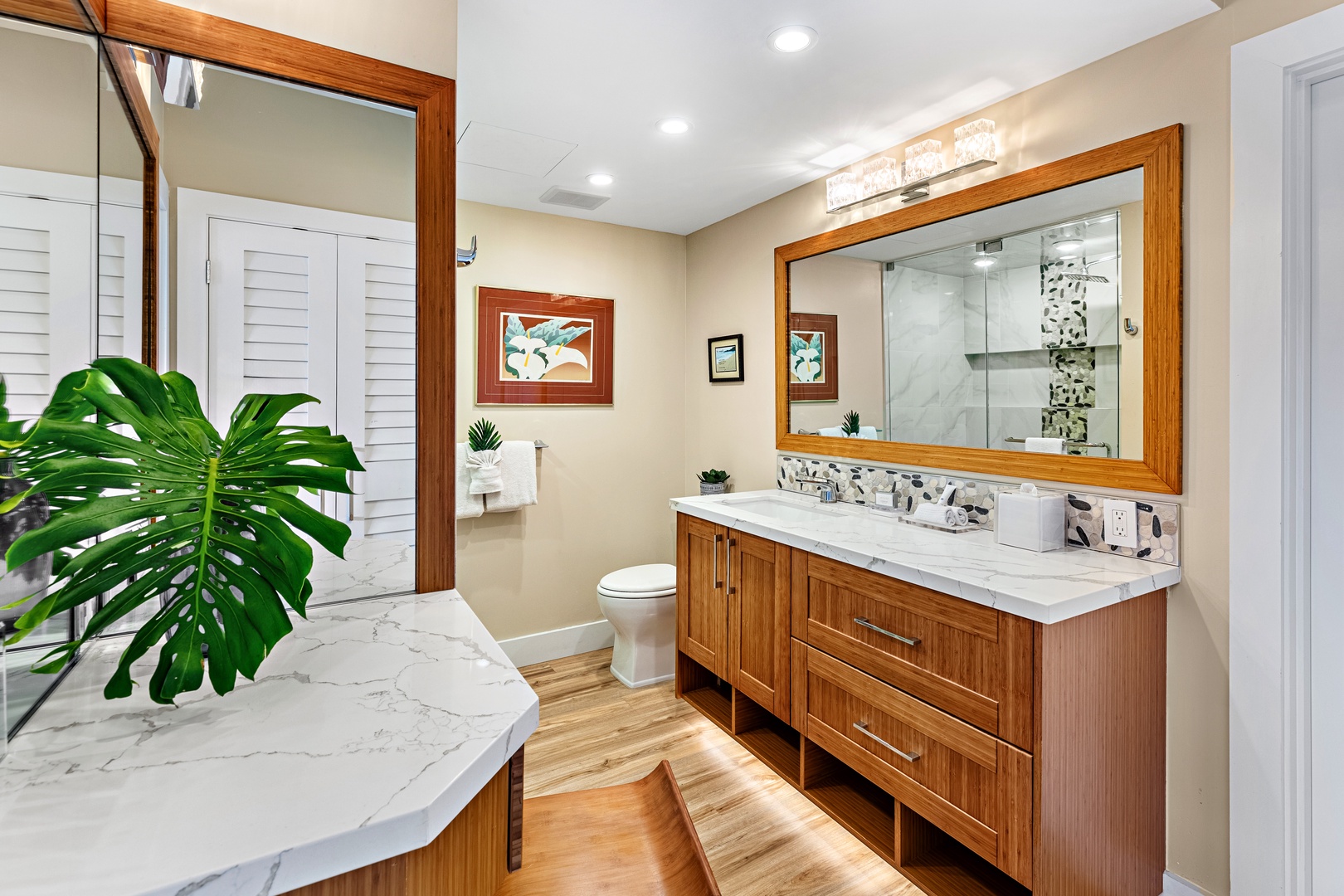 Unwind in your spacious bathroom with dual vanities, marble counters, and a luxurious walk-in shower featuring elegant tile work.