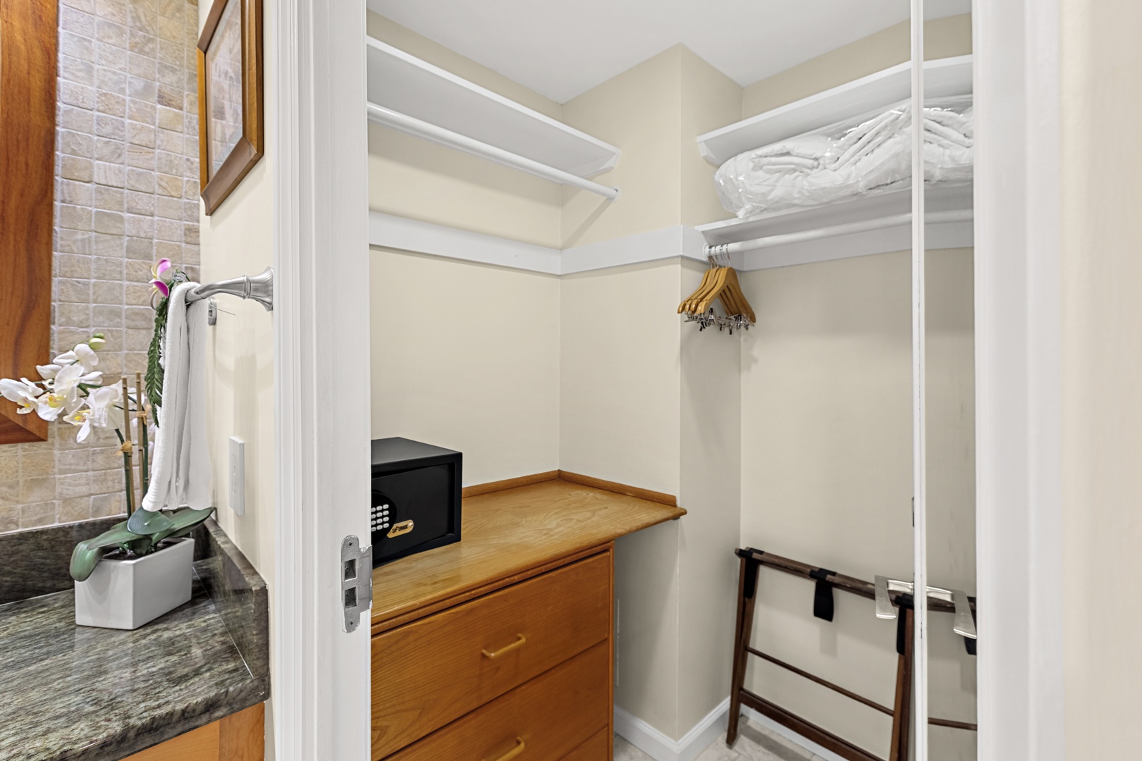 Your spacious walk-in closet offers ample storage with built-in shelving, hanging space, and drawers for all your belongings.