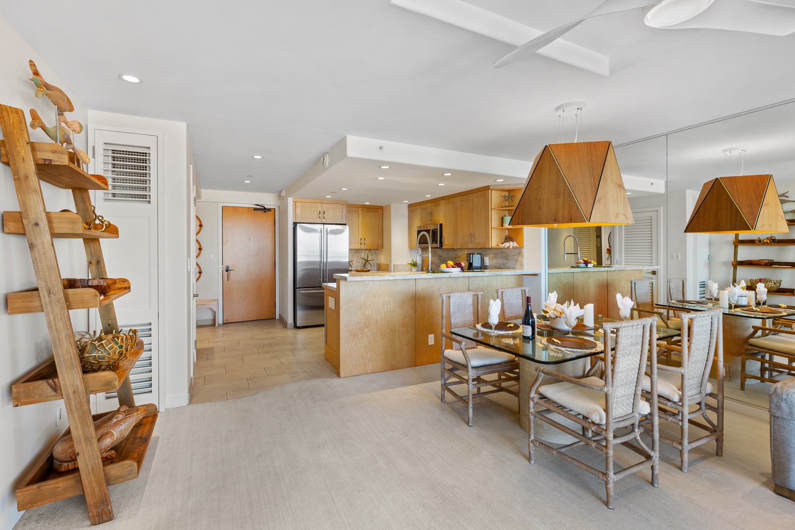 Step into this open-concept haven where warm wood tones and sleek design create your perfect entertaining space. The fully-equipped kitchen flows into the dining area, ideal for sharing meals together.