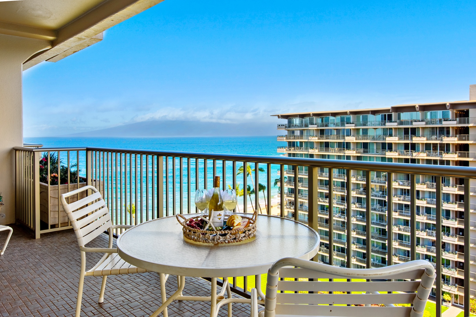 Step onto your private balcony and soak in breathtaking turquoise ocean views stretching to the horizon. Sip your morning coffee or evening wine at the outdoor table, feeling the island breeze and sunshine on your skin.