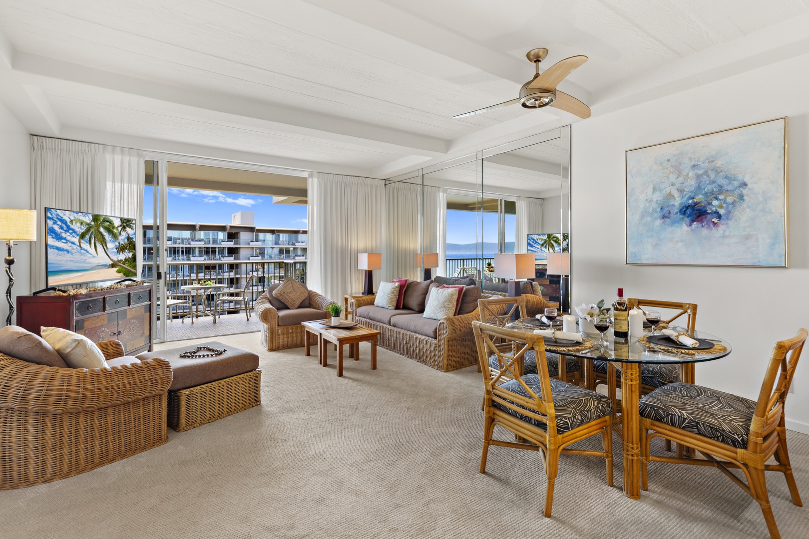 Relax in this bright, airy living space with ocean breezes, wicker seating, and coastal views. A ceiling fan keeps you cool while you enjoy the open balcony.