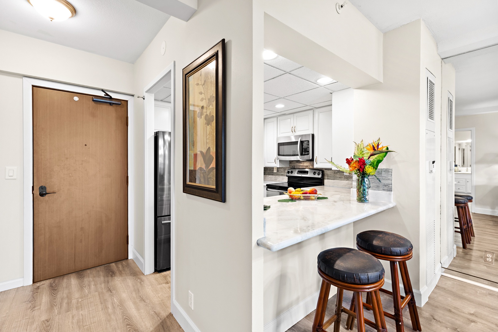 Your fully-equipped kitchen opens right off the entryway, with a breakfast bar perfect for casual meals and a sleek, modern design that makes cooking feel like a breeze.