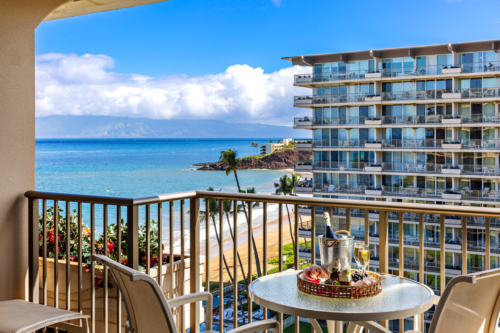 Sip your morning coffee with sweeping ocean views, swaying palms, and neighboring resort below. Your private balcony overlooks turquoise waters and golden beach—pure Hawaiian bliss.