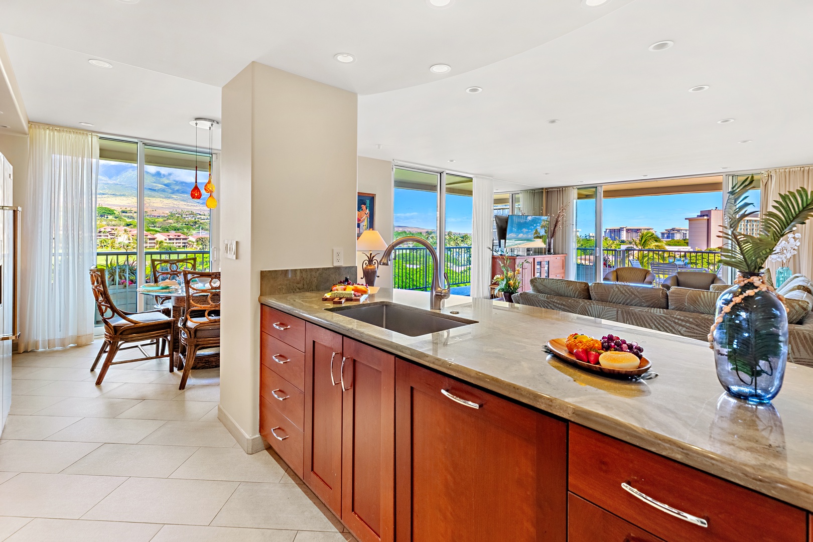 Prepare your favorite meals in a fully equipped kitchen with granite counters and premium appliances while soaking in panoramic views of the coastline and mountains through floor-to-ceiling windows.