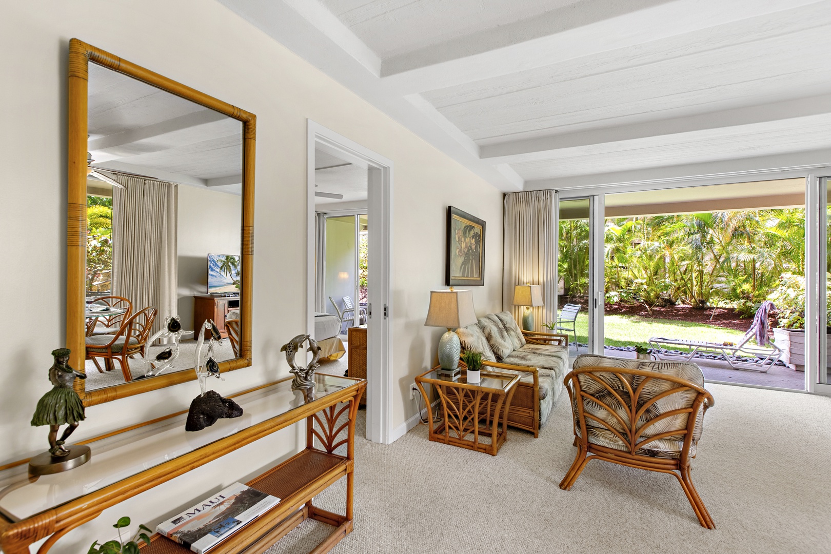 Your tropical living room opens to lush gardens, featuring bamboo furniture and island-inspired décor that creates the perfect Hawaiian retreat atmosphere.