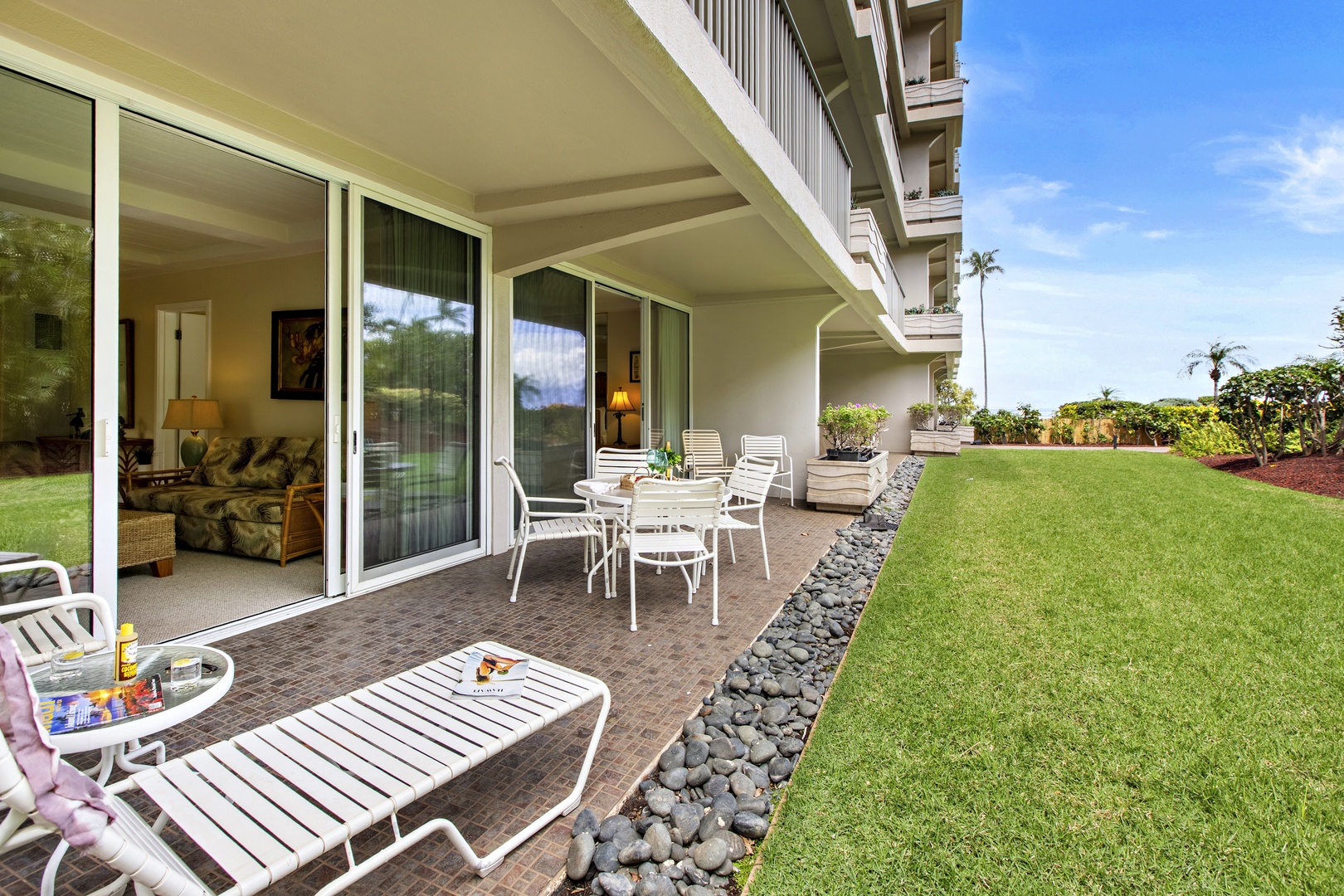 Step onto your private patio where tropical breezes meet endless green lawn. Perfect for morning coffee or evening relaxation under Hawaiian skies.