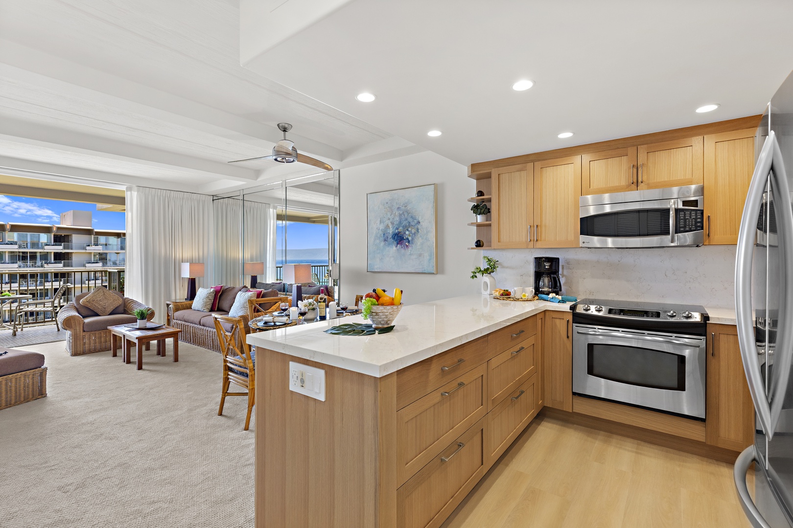Bright open-concept living with a modern kitchen island flowing into your sunny living area. Watch the ocean through floor-to-ceiling windows as you prep meals or unwind.
