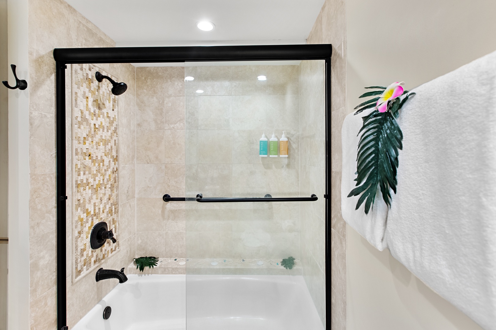 Step into your spa-like bath and shower combo with elegant tiling, sleek fixtures, and plush towels waiting just for you.