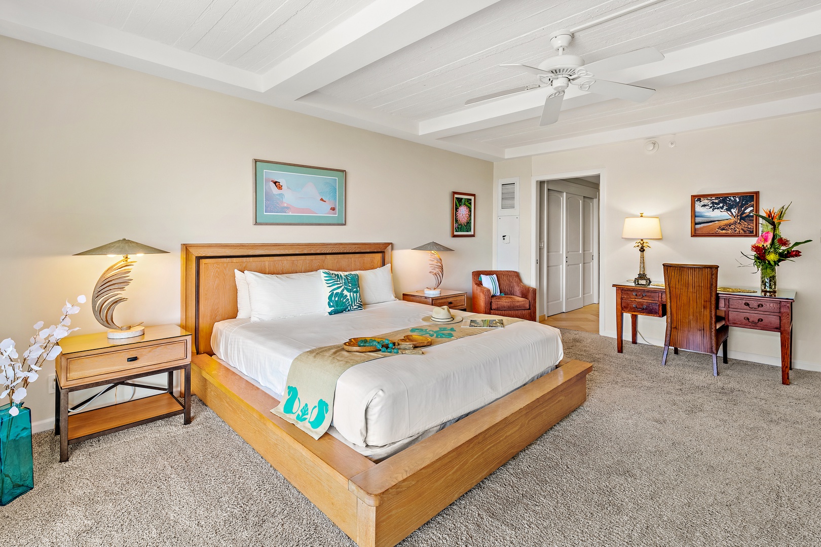 Sink into your plush island-style bed under a gentle ceiling fan. Fresh tropical touches and warm wood tones create a peaceful retreat after a day of adventure.