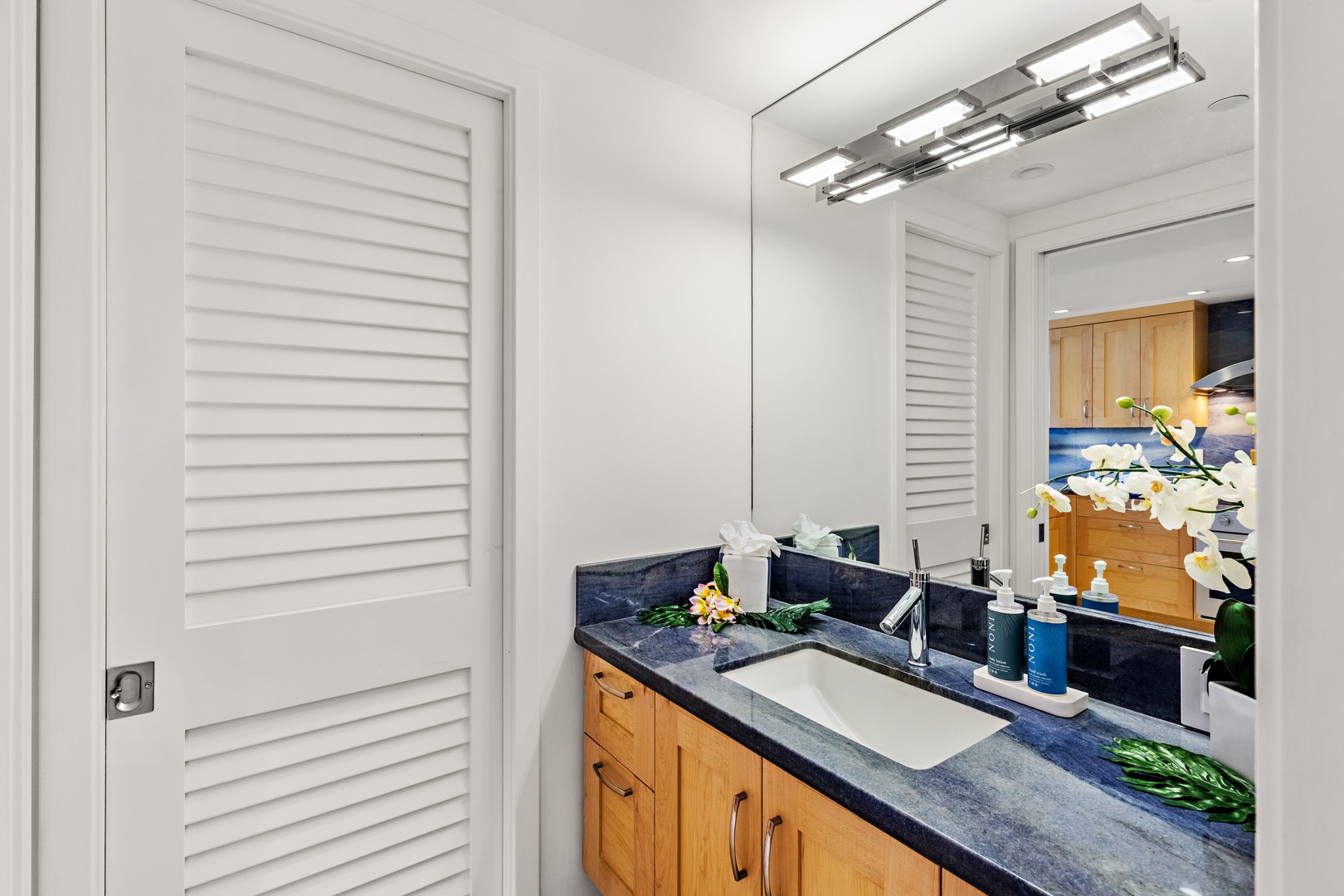 Elevated comfort and thoughtful design. A beautifully appointed guest bathroom featuring a spacious vanity and refined finishes that bring a touch of island luxury to your everyday routine.