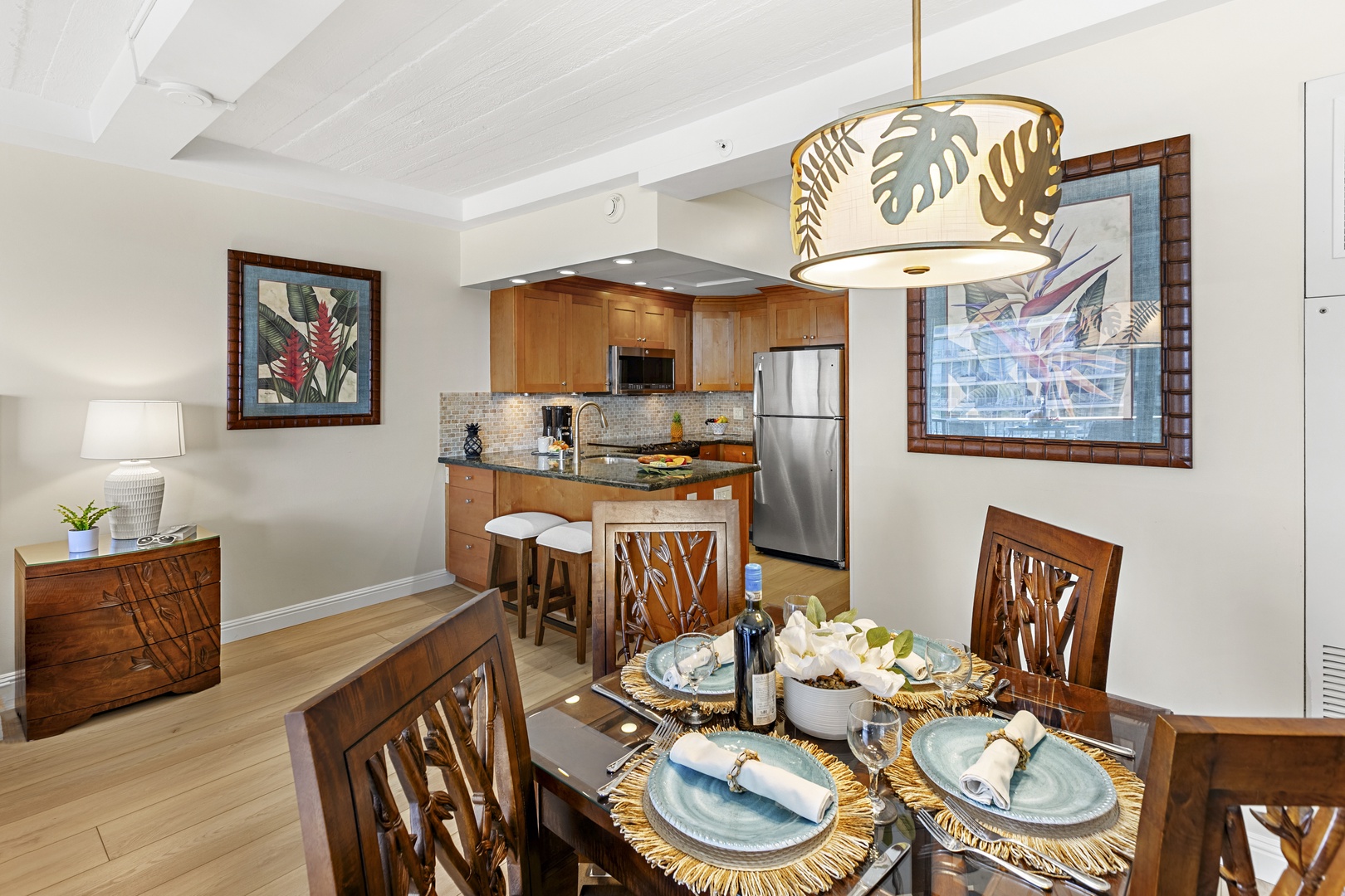 Step into your tropical-inspired dining space, where warm wood tones and island artwork create the perfect setting for memorable meals together.