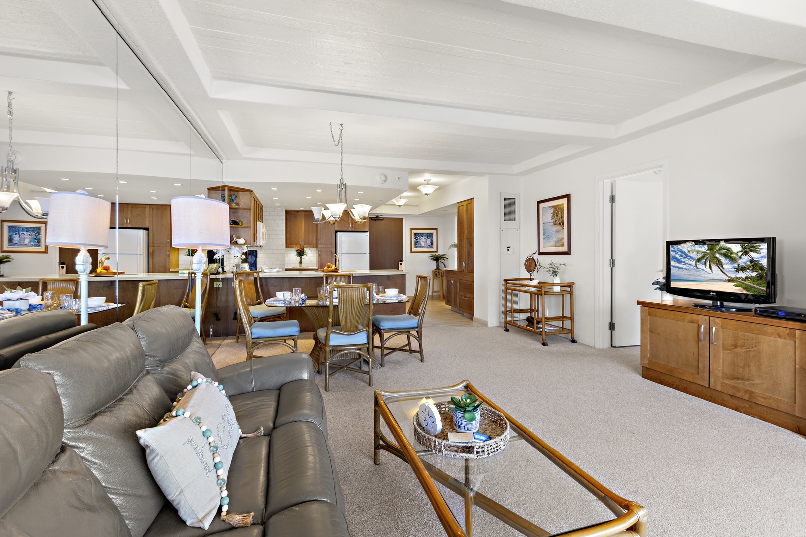 Expansive open-concept living and dining space with coordinated furnishings, soft lighting, and easy flow into the kitchen.