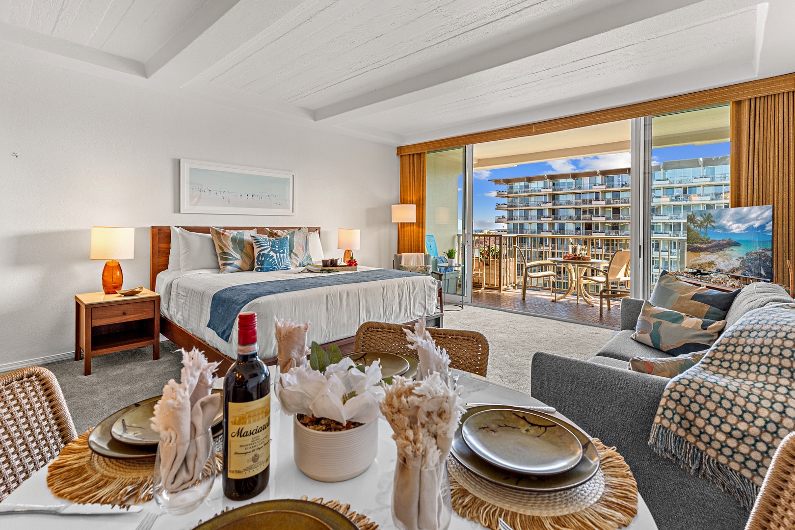 Step into your serene retreat where comfort meets coastal elegance. Relax on your private balcony overlooking turquoise waters, unwind in the plush seating, or enjoy a glass of wine at your beautifully set dining table.