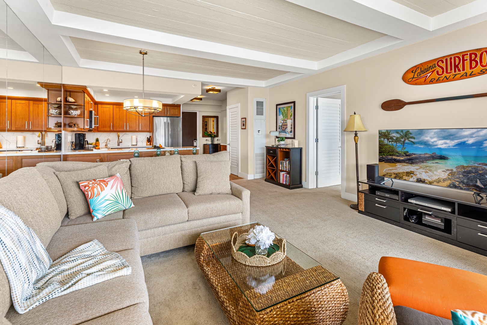 Unwind in your spacious coastal living room with cozy sectional seating and warm wood kitchen nearby.  Spacious living area featuring a comfortable pull-out sofa sleeper