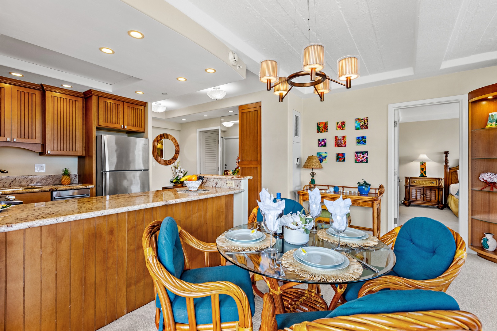 Your spacious kitchen and dining area blends warm wood cabinetry with tropical touches, creating the perfect space for memorable meals together.