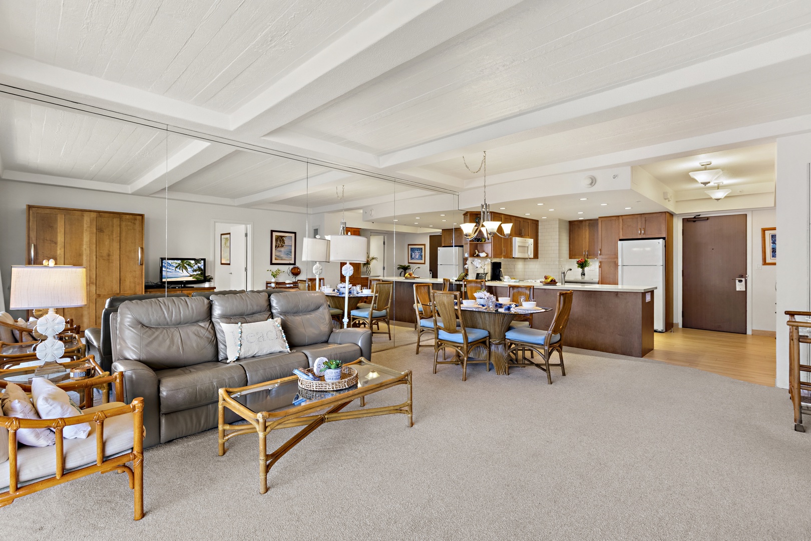Expansive open-concept living space seamlessly connecting the seating area to dining and kitchen spaces, perfect for relaxing or entertaining.