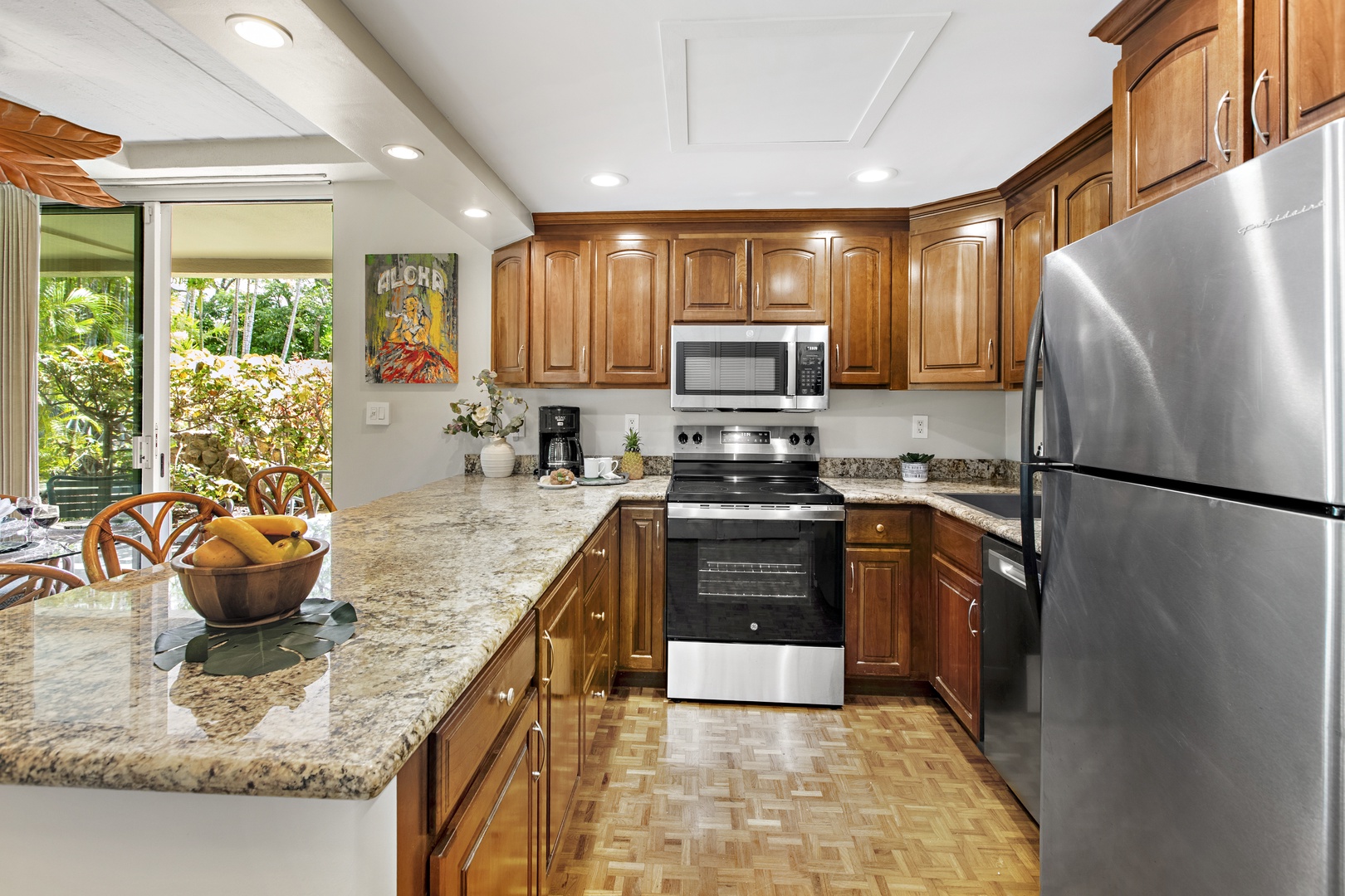 You'll love preparing meals in your fully equipped kitchen featuring granite countertops, stainless steel appliances, and garden views.